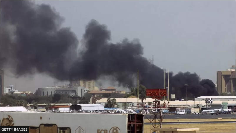 Smoke rises above buildings at Khartoum's airport