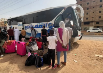 People gather as they flee clashes between the paramilitary RSF and the army in Khartoum
