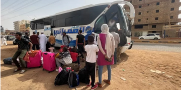People gather as they flee clashes between the paramilitary RSF and the army in Khartoum