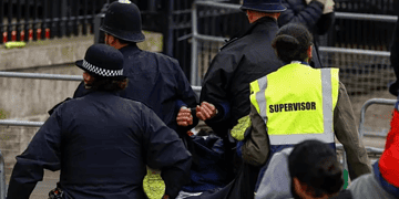 Police detain a protester